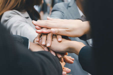 Success Teamwork Concept, Business people team joining hands outside office city background.の写真素材