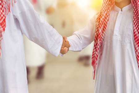 Arab middle eastern Business man handshake over blurry smart business people background, Success and...