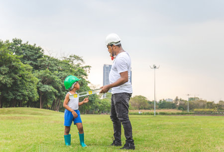Cheerful african american father and son in hard hat in the park, Happiness family conceptsの写真素材