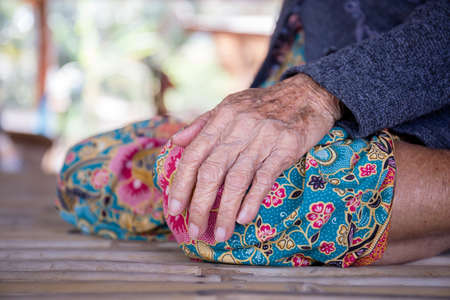 Close up of older woman hand with blurred background, Asian elderly people in the rural of asiaの写真素材