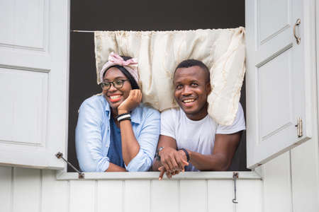 Cheerful african american couple at window, happiness family conceptsの写真素材