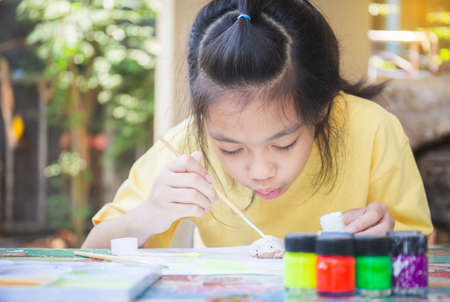 Asian little girl coloring stones, Rock craftsor creative kids, Creativity children conceptsの写真素材