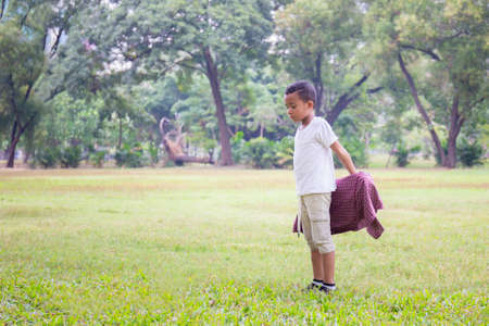 Portrait of happy kids boys funny playing outdoors in a park, Kids playing concepts.の写真素材