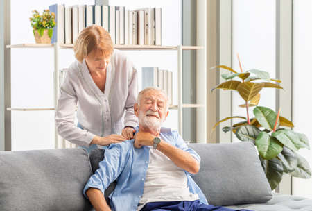 Portrait of happy senior couple in living room, Elderly woman and a man relaxing on cozy sofa at home, Happy family conceptsの写真素材