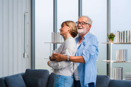 Portrait of happy senior couple dancing in living room, Elderly woman and a man dancing, Happy family conceptsの写真素材