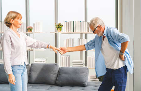 Portrait of happy senior couple dancing in living room, Elderly woman and a man dancing, Happy family conceptsの写真素材