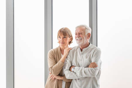 Portrait of Modern senior couple standing in living room, Happy elderly woman and a manの写真素材