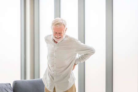 Senior man with back pain, Mature man suffering from low back pain, Old man with back painの写真素材
