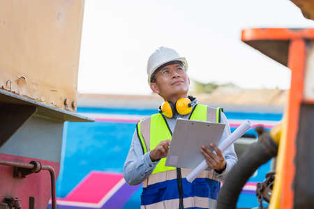 Professional technician pre-check electric diesel locomotive, Engineer man working in diesel locomotive, Safety conceptsの写真素材