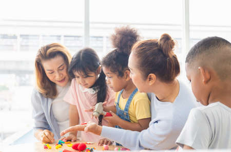 Grandmothers and children playing toys and game in living room, Grandma spending happy time with little kid girls and boyの写真素材