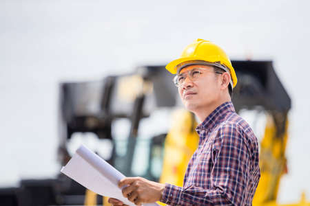 Foreman in hardhat control loading containers box from cargo, Engineer checking and inspect container in industry cargoの写真素材