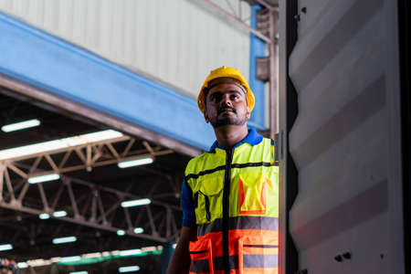 Warehouse worker working and opening the door of containers checking goods in container box, Manual worker in factory warehouseの写真素材