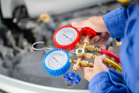 Air Conditioning Repair, Repairman holding monitor tool to check and fixed car air conditioner...
