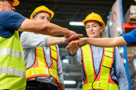 Success Teamwork Concept, Happy business people engineer and warehouse worker team joining hands after meetingの写真素材