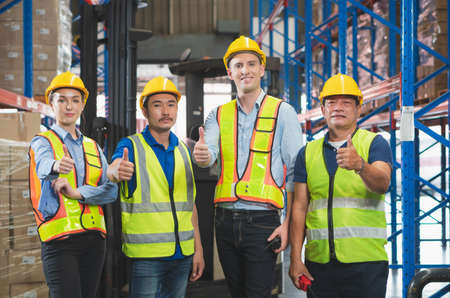 Success Teamwork Concepts, Foreman worker team smiling with showing thumbs up in a warehouse, Manager and workers professional teamの写真素材