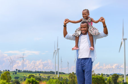 Cheerful African American father and daughter, Father carrying daughter on shoulders, Little girl on the shoulders of her dadの写真素材