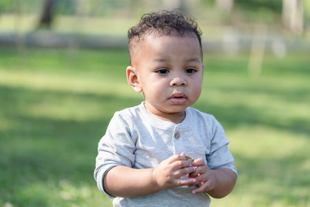 Cute little kid boy playing outdoors in the garden, Child boy walking in the parkの写真素材