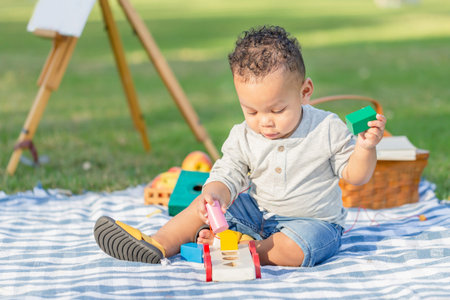Cute little boy play toy at the garden, Child boy playing with little wooden toy cars outdoor