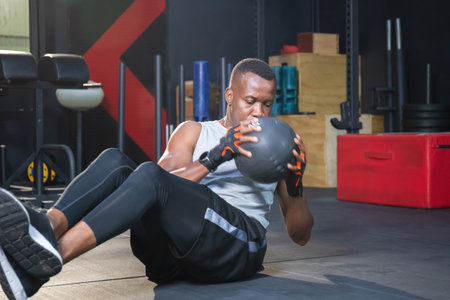 Young man training with functional gymnastic in the gym, Fitness man warming up in fitness gym, Bodybuilding exercise and sport workout trainingの写真素材