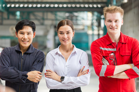 Managers and auto mechanic team standing with arms crossed in a repair garage, Car repair and maintenance conceptsの写真素材