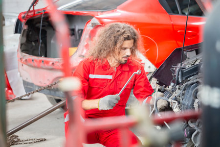 Technician man working in auto repair shop, Car mechanic in repair garage, Car repair and maintenance conceptsの写真素材