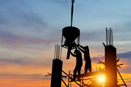 Silhouette of worker team at building site with clipping path, construction site at sunset in evening timeの写真素材