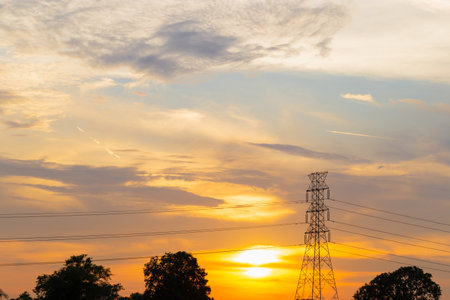 Silhouette of High voltage electric tower at sunset evening time, Sky at sunset time background
