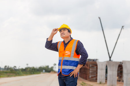 Engineer checking project at building site, Foreman worker in hardhats on construction site