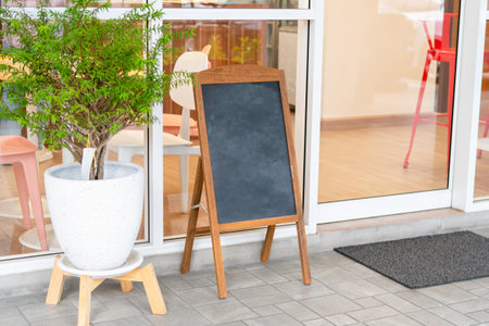 Advertising stand banners mockup, Mock up of a standing poster, Blank wood frame outdoor stand mockup poster display at store frontの写真素材