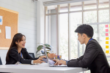 Business people meeting for analysis to plan business strategies, Two young business colleagues in modern officeの写真素材
