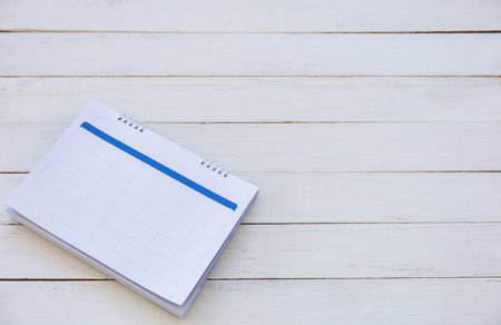 Calendar on white wood texture backgrounds with copy space for your concepts, wooden table top view