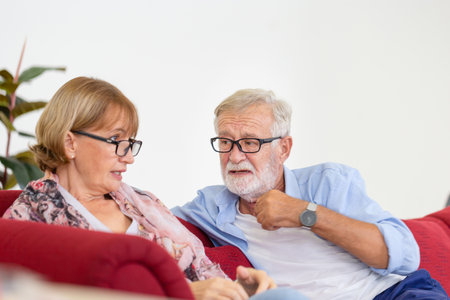 Portrait of happy senior couple in living room, Elderly woman and a man relaxing on cozy sofa at home, Happy family conceptsの写真素材