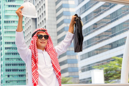 Arab Middle Eastern Businessman with a blurred city background. Muslim engineer man checking project at building siteの写真素材