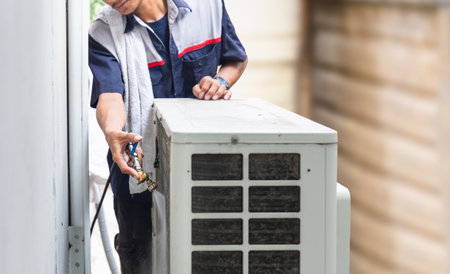 Technician man cleaned mold in the air conditioning system, Repairman washed dirty air conditioner, Maintenance and service conceptsの写真素材