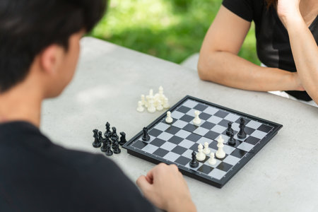 Mother playing chess with a son, Asian family relaxing hobbies playing chess in a parkの写真素材