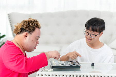 A group of friends playing a game of checkers in living room at home