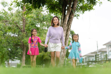 Asian mother and daughter walking outdoor go to swimming pool