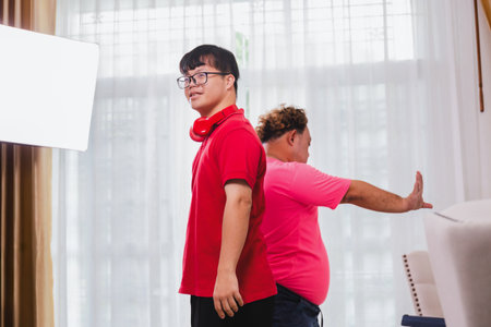 Funny influencer and friends dancing and singing at home, Cheerful young Asian men dance in living...