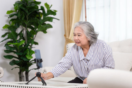 Senior Asian female blogger influencer recording video blog for her channel, Woman influencer live...