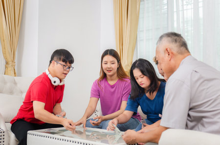 Senior man and grandchild relaxing in living room, Grandchild interacting with friends and playing...