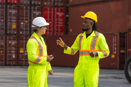 Industrial foreman worker team checking and managing containers boxes at cargo containers shipping,...