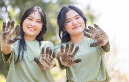 Woman volunteering team showing dirty hand with glove, Charity and ecology conceptsの写真素材