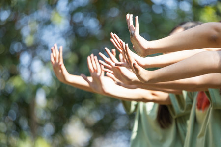 Women team showing dirty hands outdoors, Cheerful young Asian female volunteer team in park for...