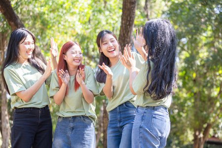 Happy women volunteers team showing dirty hands outdoors, Cheerful young Asian multigenerational group enjoying outdoor teamworkの写真素材