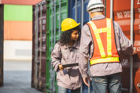 Logistics Team Discussion at Shipping Yard, Engineer man and Businesswoman Inspecting Contrainers...