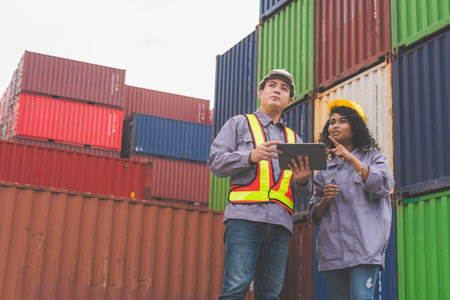 Engineer and Foreman Dock Worker Inspecting Containers Box at Cargo, Logistics Team at Shipping Yardの写真素材