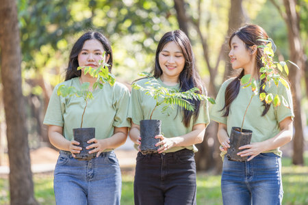 Group of Female volunteer people team preparing to plant trees, Young Asian woman team volunteer in park for charity eventの写真素材