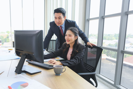 Supervisor training and suggesting about work to colleagues, Asian businesspeople team meeting in modern office, Professional business meeting in office, Teamwork and brainstorming conceptsの写真素材