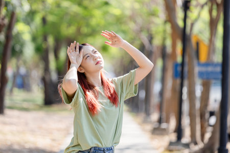 Young Asian woman walking in the park on a summer day