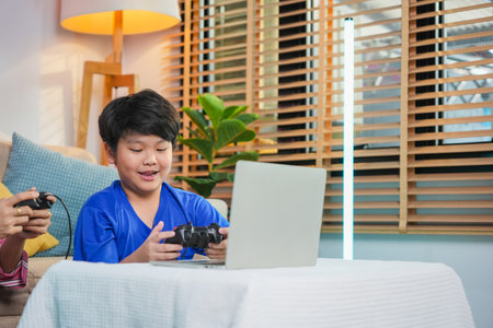 Boy Playing Video Game on Laptop Indoors, Mother and Son Playing Video Game at Home, Happy Family...